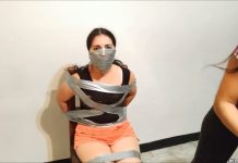 Over the nose tape gagged girl tied to a chair