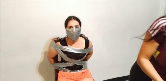 Chair Taped Girl With Bridged OTN Tape Gag Over the nose tape gagged girl tied to a chair