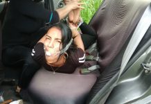 Barefoot girl hogtied in car