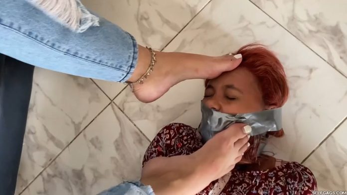 Gagged girl with feet in face