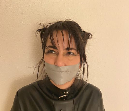 Straitjacketed Cheerleader Tape Gagged Tape gagged brunette in straitjacket bondage