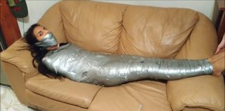 Sock Gagged Girl Wrapped Up Tight On Sofa Girl restrained with duct tape wrapped around her body from her feet to her shoulders