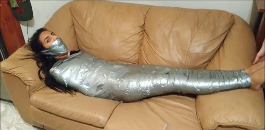Sock Gagged Girl Wrapped Up Tight On Sofa Girl restrained with duct tape wrapped around her body from her feet to her shoulders