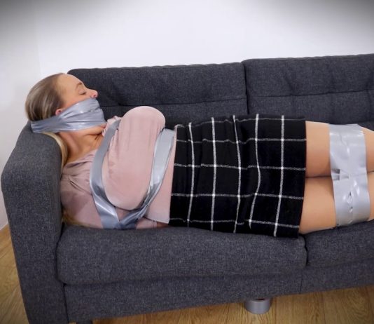 This School Teacher Loves Bondage – Beth Bennett A gagged school teacher is stuck in tight tape bondage on a sofa