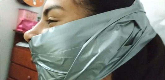 Little Girl Silenced With BIG Tape Gag! A beautiful girl is wearing a big tape gag