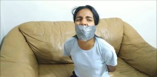 Panty Hooded Girl Gagged With Socks And Tape A tied-up girl is tightly gagged with duct tape wrapped around her head