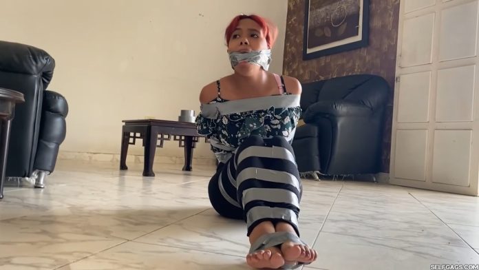 Tape tied girl in barefoot bondage