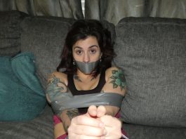 Tattooed woman in tape bondage