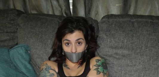 Tattooed Woman In Tape Bondage Tattooed woman in tape bondage