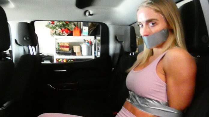 Blonde girl tape bound and gagged with duct tape