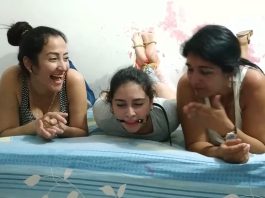 Barefoot girl hogtied and ball gagged by two women