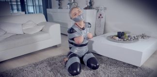 Topless Blonde Frogtied And Heavily Gagged A gagged woman in a catsuit has her perky tits exposed in bondage. She loves being tied up and gagged.