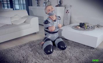 Topless Blonde Frogtied And Heavily Gagged A gagged woman in a catsuit has her perky tits exposed in bondage. She loves being tied up and gagged.