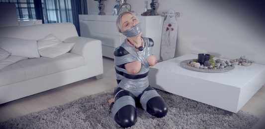 Topless Blonde Frogtied And Heavily Gagged A gagged woman in a catsuit has her perky tits exposed in bondage. She loves being tied up and gagged.