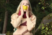 Blonde sweater girl self-gagged in forest