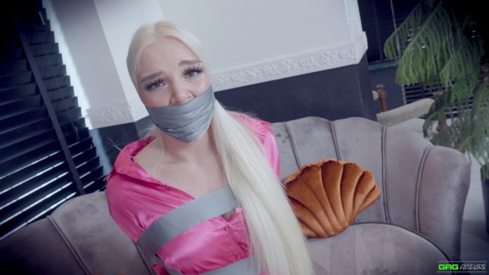 Blonde woman tape wrap gagged in tight tape bondage