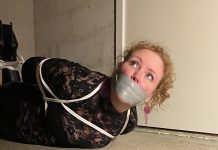 Hogtied party girl gagged with tape on basement room floor