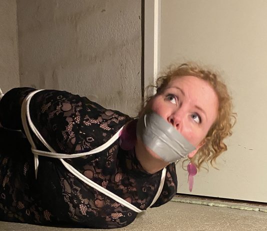 Kidnapped Party Girl Bound And Hidden Away Hogtied party girl gagged with tape on basement room floor