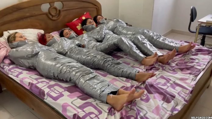 5 barefoot girls gagged in strict duct tape mummification bondage