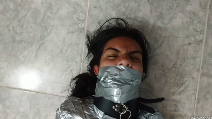 Collared girl heavily gagged with real duct tape