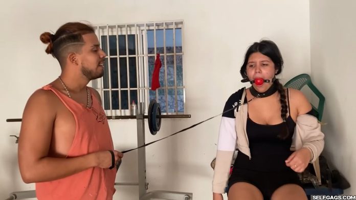 Ball gagged girl collared and leashed while working out on a bike