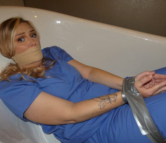 Kidnapped Nurse Tape Bound in the Tub Tape-tied-nurse-kidnapped-gagged