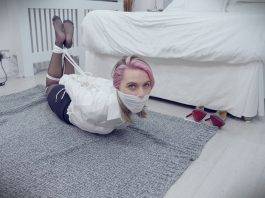Woman wearing pantyhose is hogtied and otm gagged in blouse on the floor