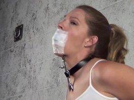 Medical tape gagged woman with heretic's fork tied to her neck