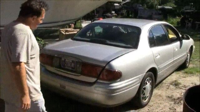 A BDSM Gif showing a kidnapped woman bound and gagged in a car trunk. She is sold into bondage slavery and carried away over the shoulder by a man