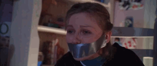 A gif showing actress Kirsten Dunst bound and gagged in the movie Small Soldiers