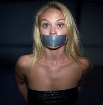 Danish Event Girl Asta Bound and Tape Gagged in Darkness Blonde Danish event girl named Asta, duct tape gagged and bound, wearing a black glittering top, wide-eyed and staring fearfully in a dark setting.