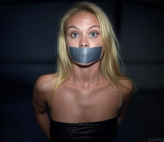 Danish Event Girl Asta Bound and Tape Gagged in Darkness Blonde Danish event girl named Asta, duct tape gagged and bound, wearing a black glittering top, wide-eyed and staring fearfully in a dark setting.