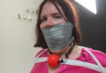 Secretray Snowflake is tied to a chair and gagged with cloth and tape—bound and silenced in a strict office bondage scene.