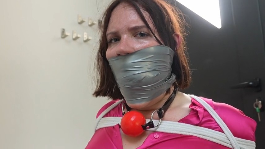 Secretray Snowflake is tied to a chair and gagged with cloth and tape—bound and silenced in a strict office bondage scene.