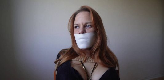 June Chair-Tied and Gagged With Microfoam – Blueeyedbondage Close-up of June’s tightly taped mouth with microfoam gag