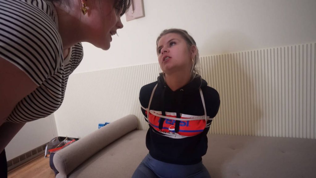 Summer in tight Pepsi hoodie and leggings sits helplessly on the couch, arms already pinned with white duct tape as jealous Snowflake looms over her, ready to stuff and tape-gag her mouth – Blueeyedbondage step-sister revenge bondage begins.