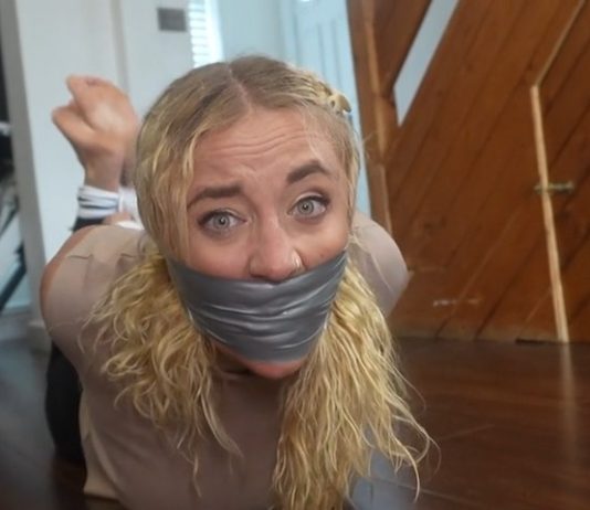 Zoey Ziptie Tightly Gagged and Hogtied by the Plumber – FrenchBondage Zoey’s gagged face in close-up, duct tape pressing over bulging sock gag