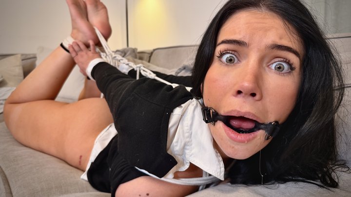 Tatti with wide shocked eyes and ring gag drooling heavily while her bound legs are held high on the sofa – Tatti Roana Bondage