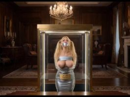 Missing Teacher Julie Millard Duct Taped & Displayed in Billionaire’s Glass Case – AI Bondage Wide shot of the glass display case elevating with bound and gagged teacher Julie Millard inside opulent room
