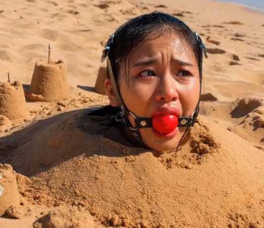 Southeast Asian Harness Ballgagged & Bucket Hooded on Beach – AI Bondage Close up of terrified Southeast Asian beauty with thick harness ball gag strapped in her mouth, eyes wide with fear