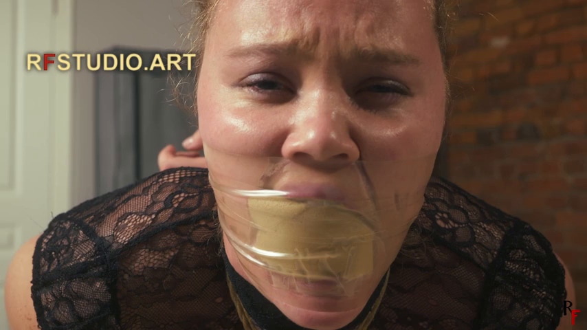 Vanda's face with a sponge stuffed mouth sealed under clear tape