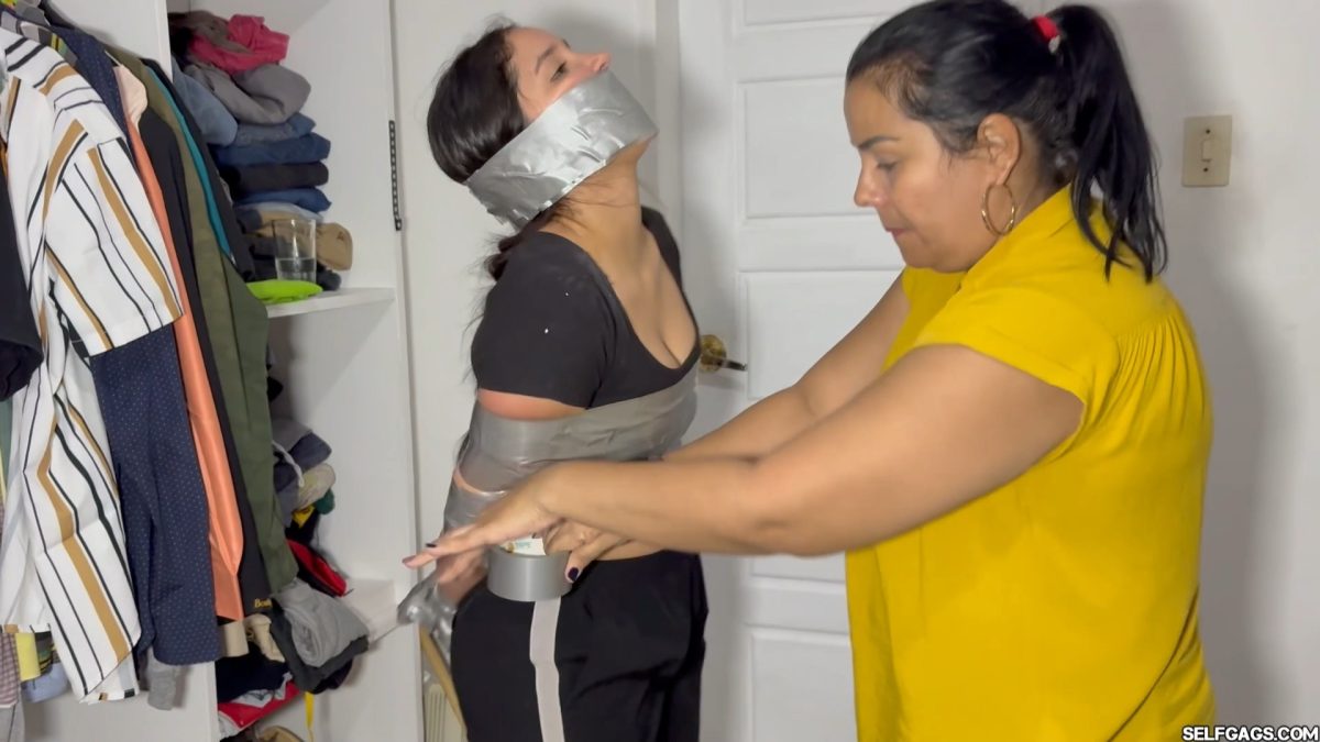 Lau applying more silver duct tape around Nana’s waist during intense bondage Selfgags
