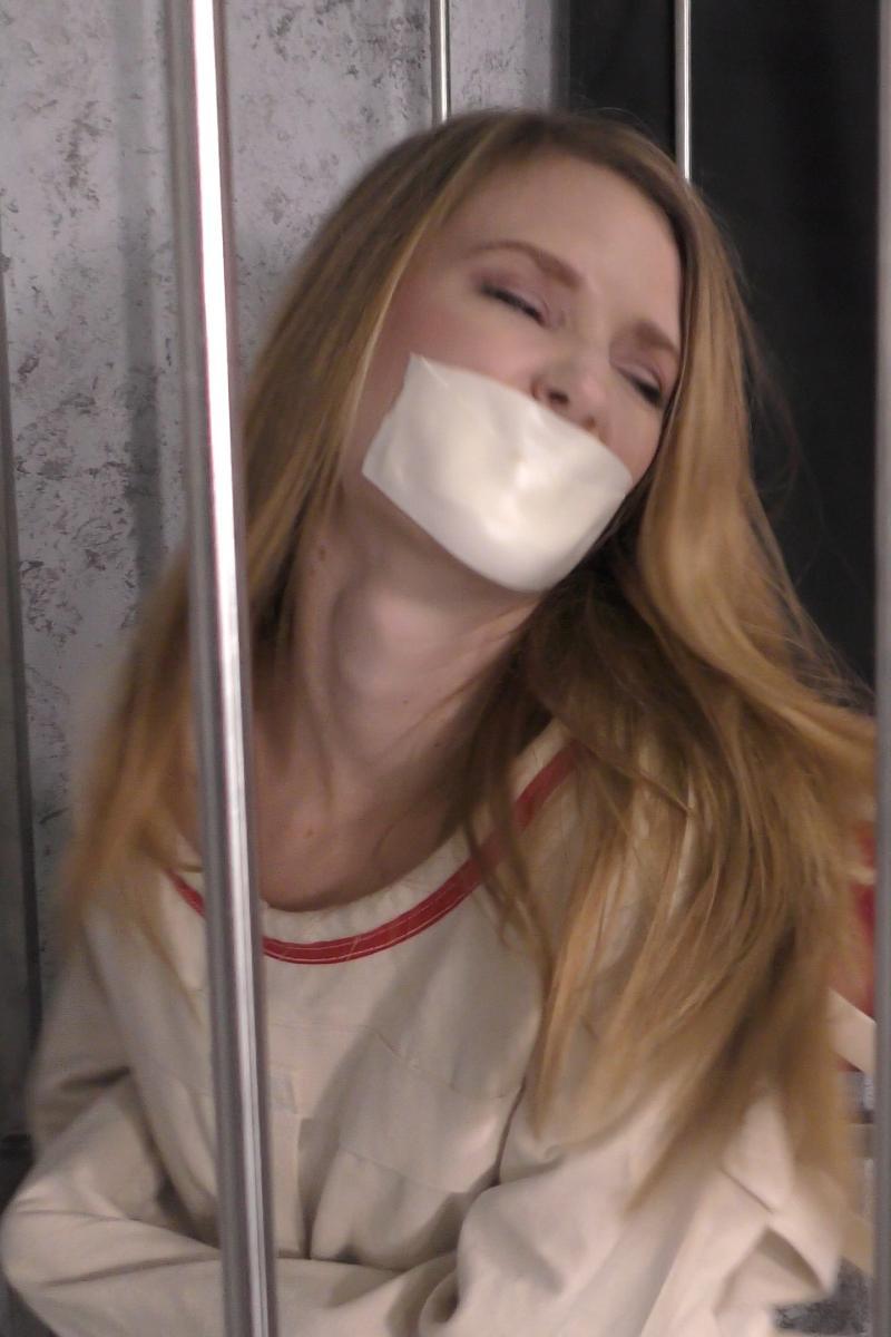 Ashley-Lane-tape-gagged-in-straitjacket-bondage-13