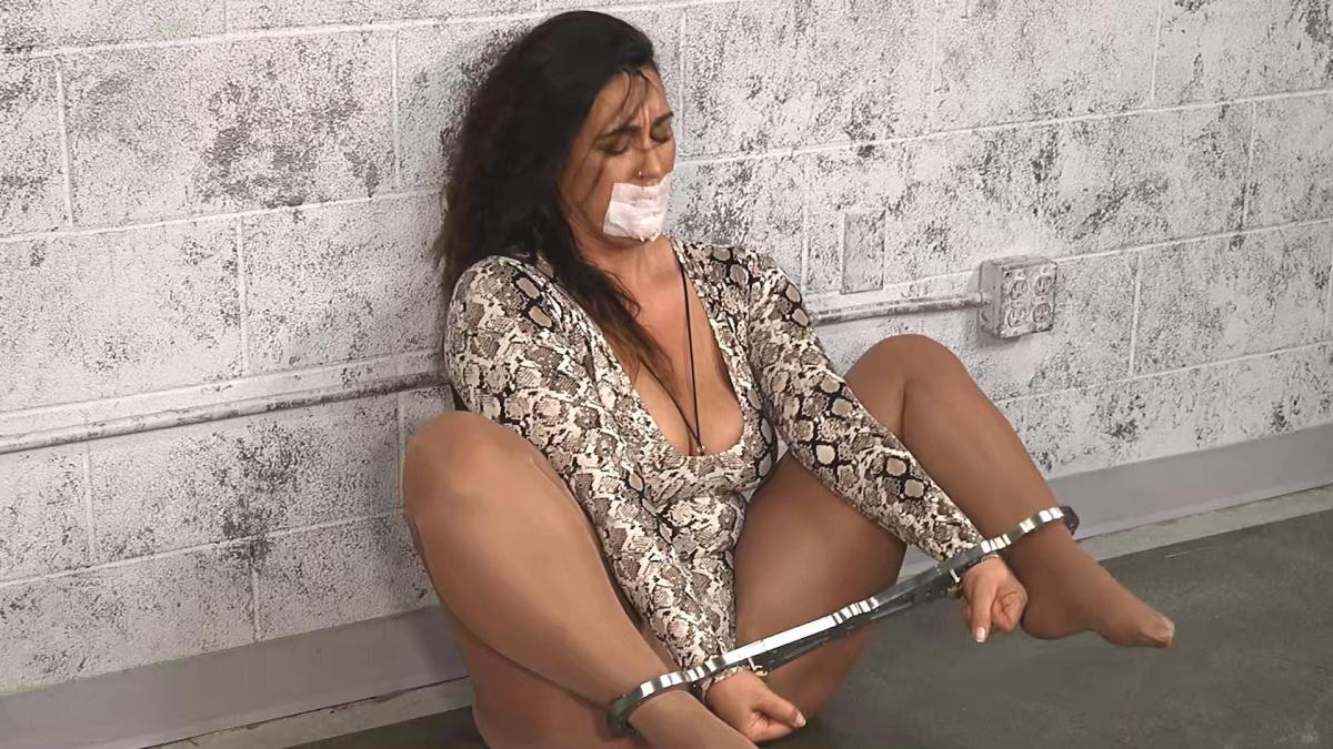 Gagged-Snakeskin-Lady-Cuffed-In-Steel-11