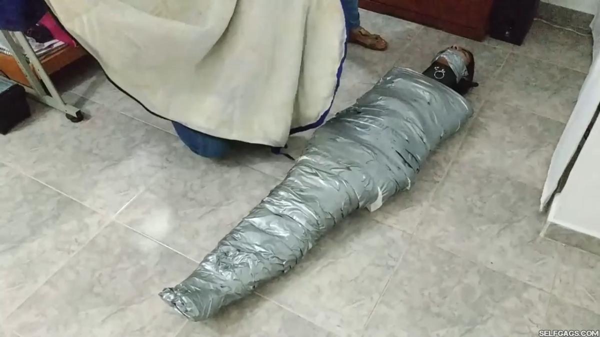 Girl-Mummified-By-Two-MILFs-23