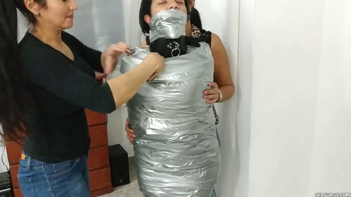 Girl-Mummified-By-Two-MILFs-30