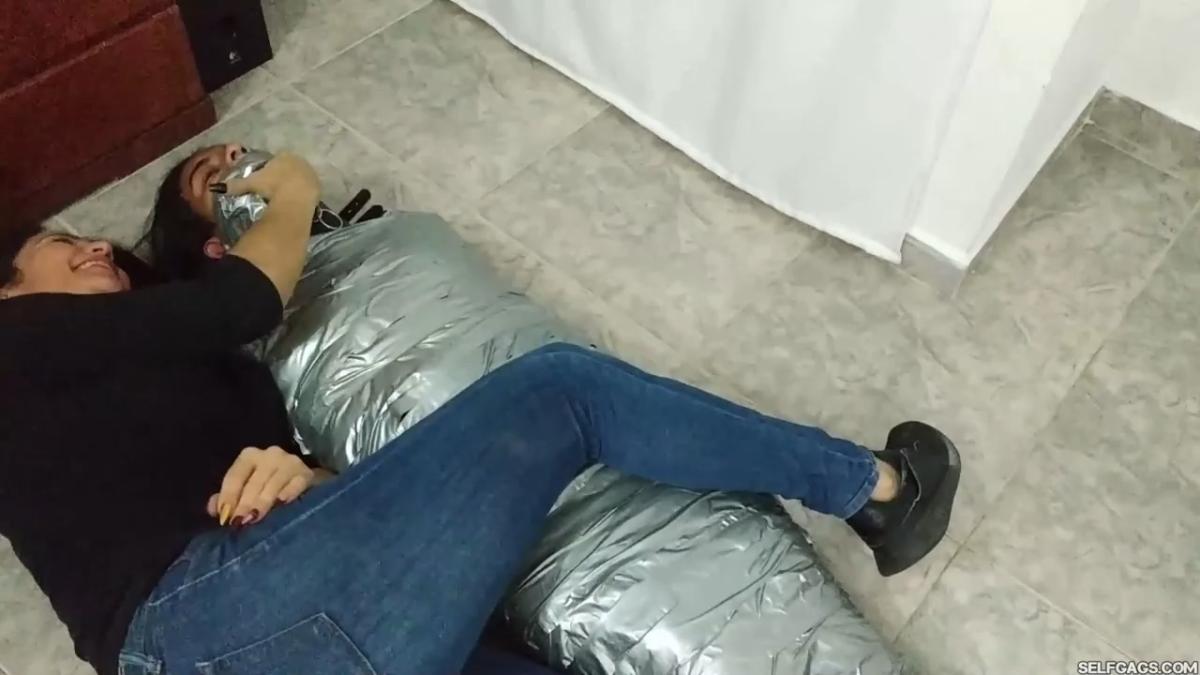Girl-Mummified-By-Two-MILFs-35
