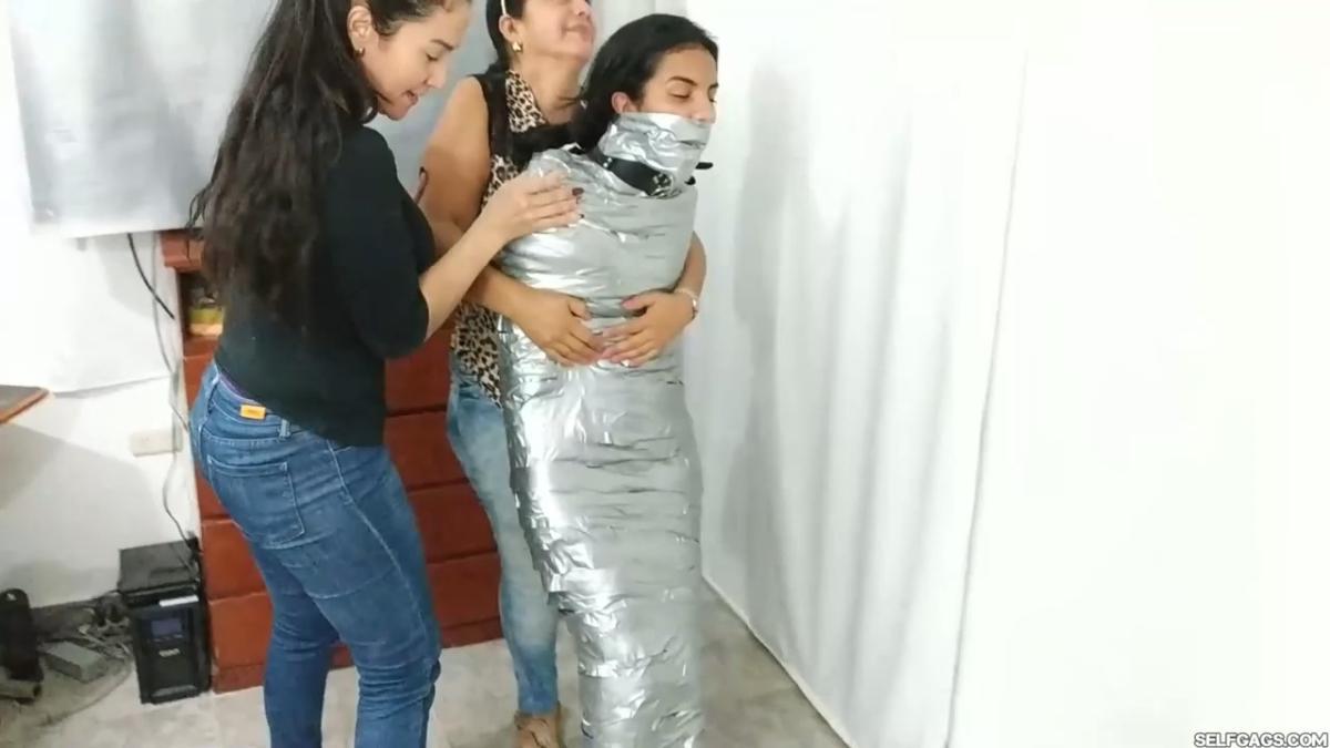 Girl-Mummified-By-Two-MILFs-37