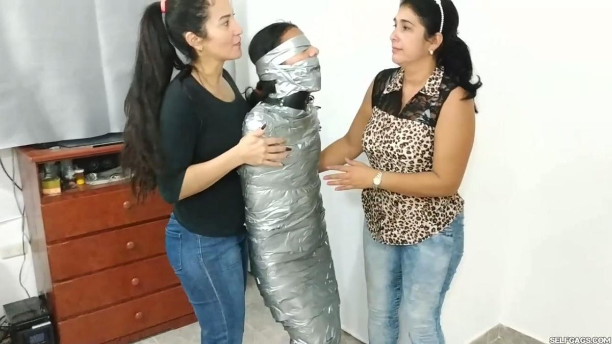Girl-Mummified-By-Two-MILFs-44