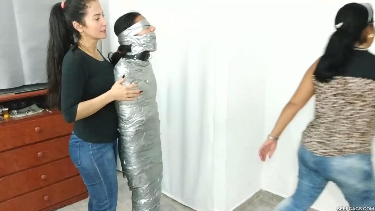Girl-Mummified-By-Two-MILFs-45
